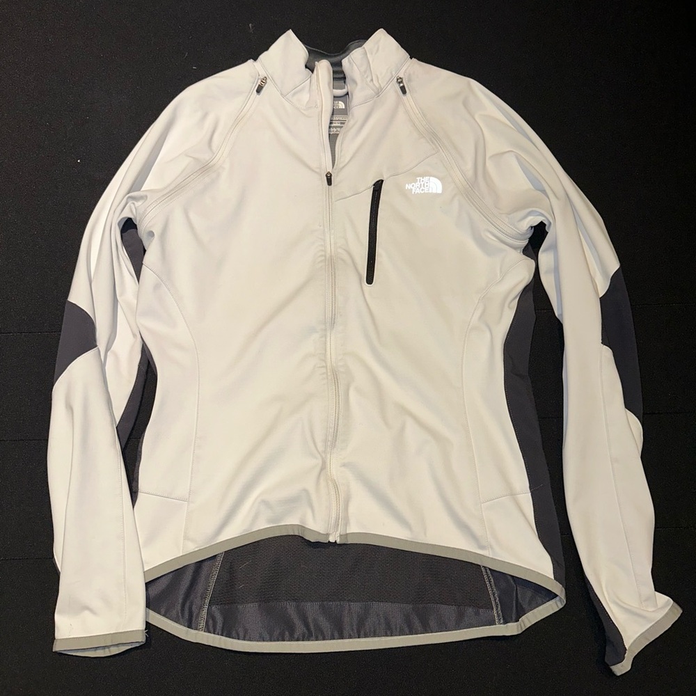 White/cream North Face jacket/vest with removable sleeves.